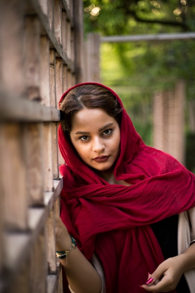 Woman leaning on white fence