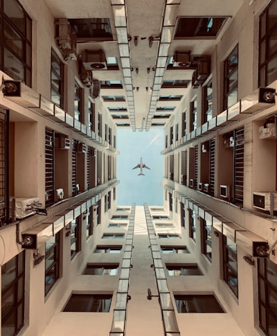 An airplane flying through a very tall building