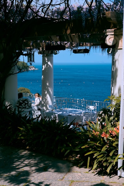A person sitting at a table in front of a pool