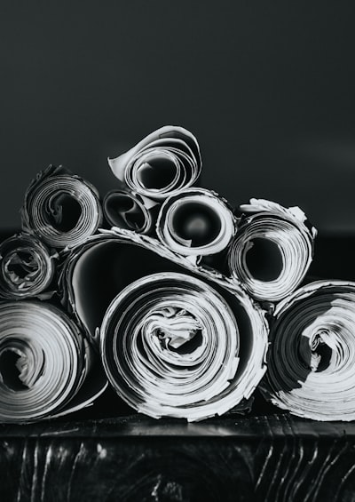 Grayscale photo of rolled papers