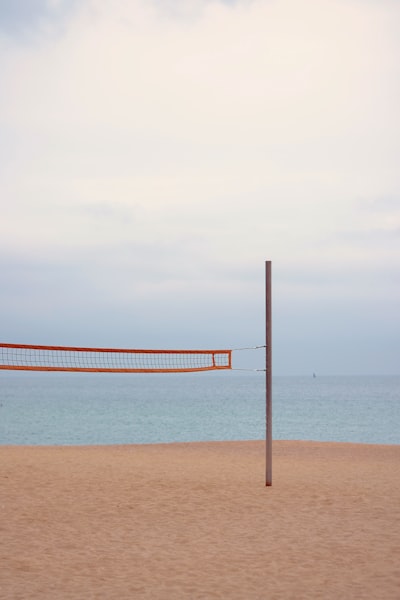 Orange and white striped hammock on beach during daytime