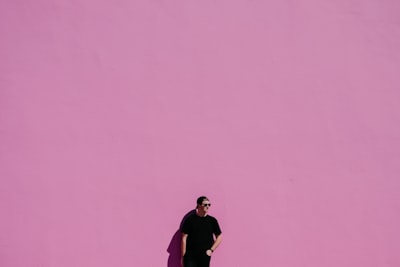 Man against pink wall