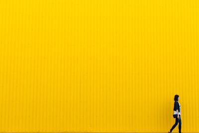 Yuliia Kutsaieva near yellow wall of supermarket