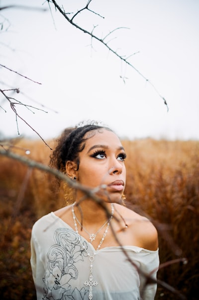 A woman standing in a field of tall grass
