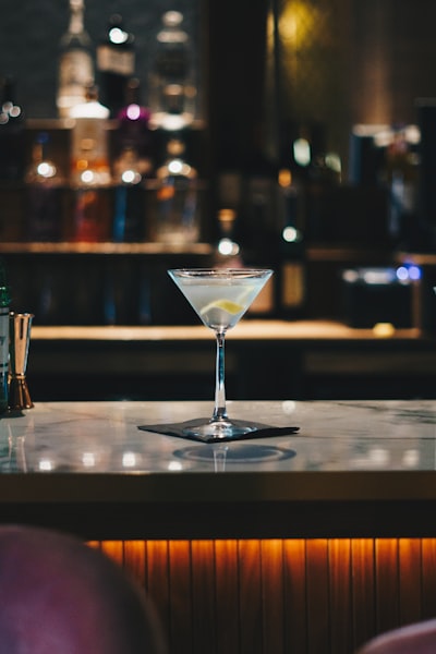 Clear martini glass on brown wooden table