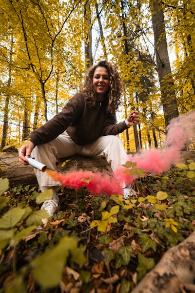 girl with smoke tube in the forest