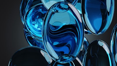 A group of blue glass balls on a black background