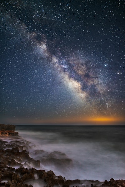 Rocky seashore during starry night