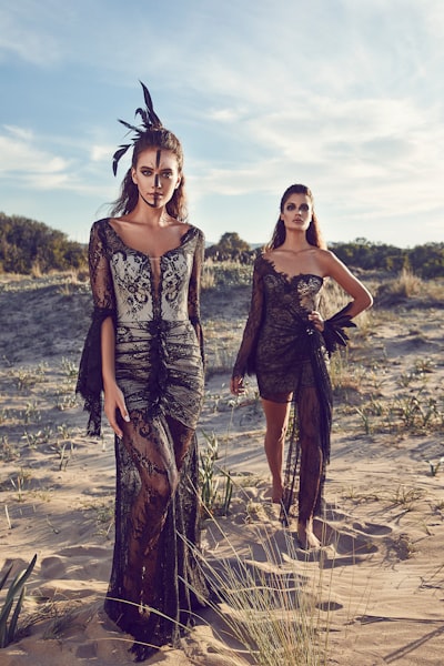 Women wearing black lace dresses in dessert