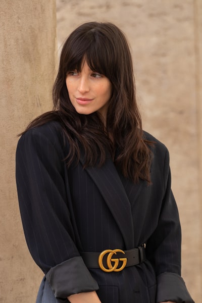 Woman in black coat and black gucci belt