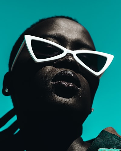 Woman wearing white framed edgy sunglasses