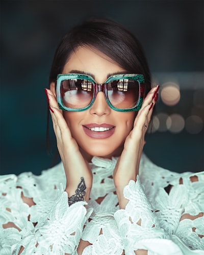Woman wearing green framed sunglasses
