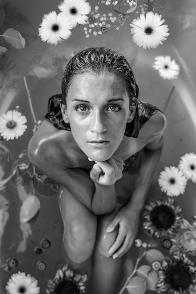 Woman in flower bath in black and white