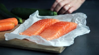 Raw fish meat on brown chopping board