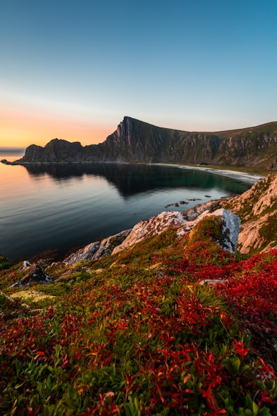 A view of a body of water with a mountain in the background