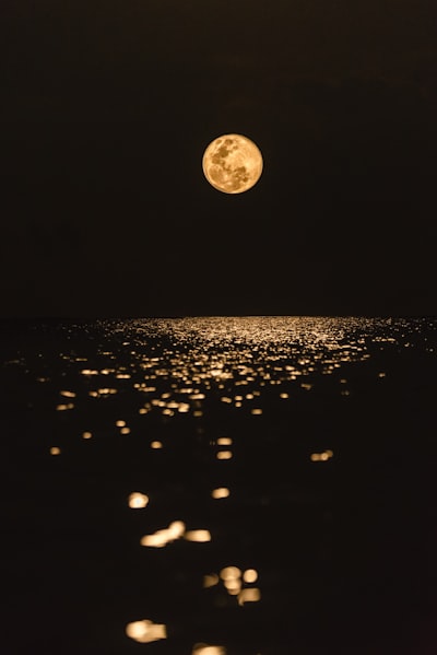 Full moon over the body of water