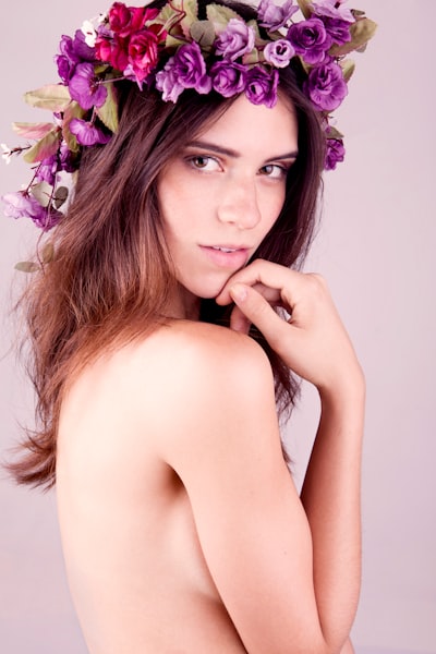 Topless woman with purple flower on her head