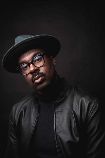 A man wearing a hat and glasses