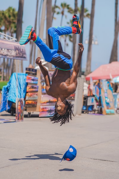 Man doing a backflip on the Venice boardwalk in California