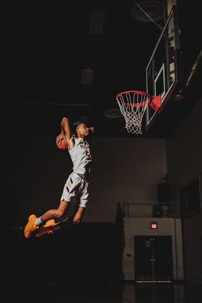 2 boys playing basketball on basketball court
