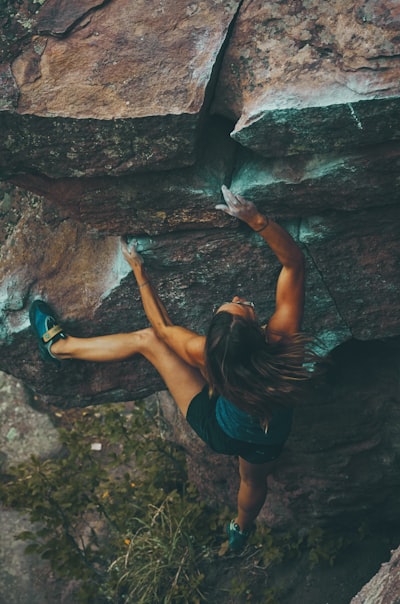 Photo of woman climbing mountain