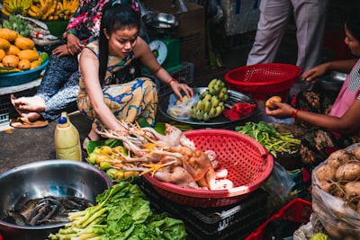 Woman holding fruits while crouching