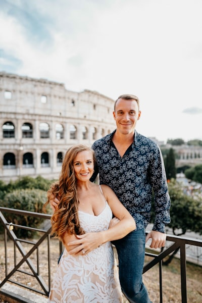 Couple in front of the Roman Colosseum, Rome Italy. Happy couple, smiling couple, couple holding each other. Alecia Sanfilippo and Alex Sanfilippo founder of PodPros, PodPros.com