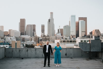 Man and woman standing on gray concrete floor during daytime