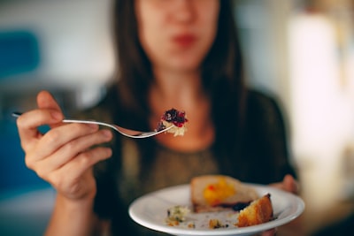 Woman holding plate of cake