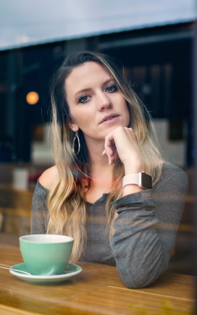 Woman sitting beside table