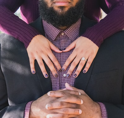 Person standing at the back of man while touching his chest