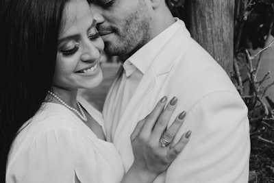 Man in white dress shirt kissing womans cheek