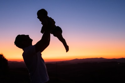 Silhouette of man and woman kissing during sunset