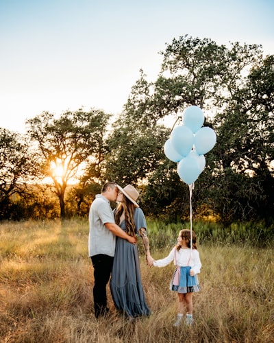 A couple of people that are holding some balloons