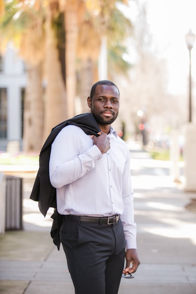 Fortune Vieyra wearing black business attire while standing.