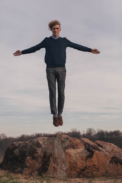 Man jumping while open arms