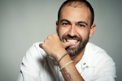 Man in white dress shirt wearing green bracelet