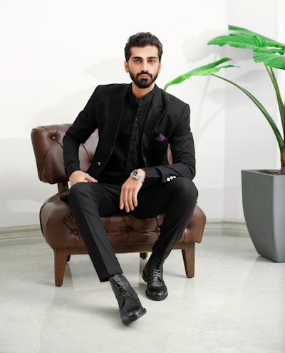 A man in a suit sitting on a chair