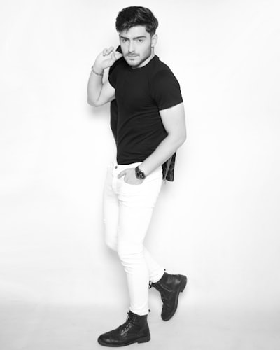 A man in a black shirt and white pants