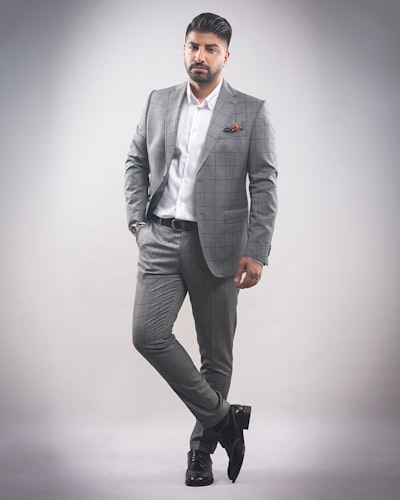 Man in gray suit jacket and black dress pants