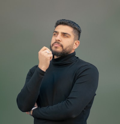 A man wearing a black turtle neck sweater