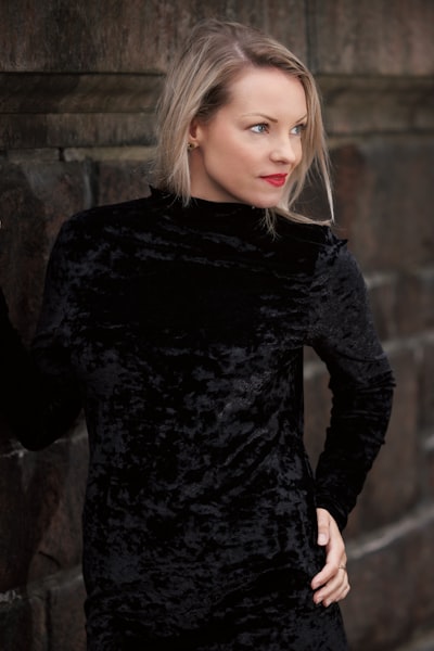 Half body portrait of a beautiful young woman wearing a black dress looking sideways. Model Sofie (Instagram: @sofiepersson87) in Stockholm, Sweden.