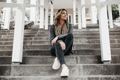 Woman in black and brown animal print coat walking on stairs