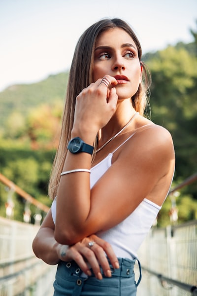Woman in red and white floral tube dress wearing brown sun hat