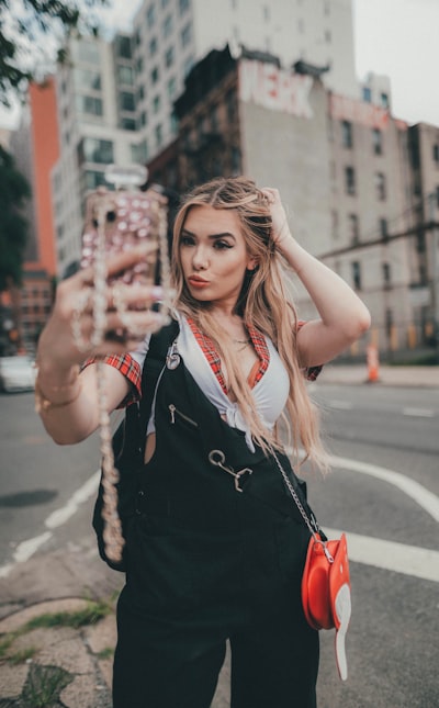 Selective focus photography of jolly woman using peace hand gesture