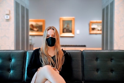 Woman seated on couch in art gallery