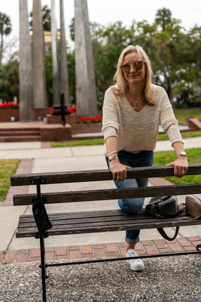 A woman leaning against a tree in a park