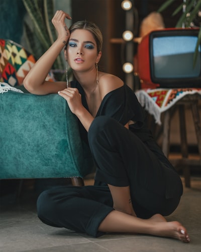 Fashion model seated on floor in retro-styled room