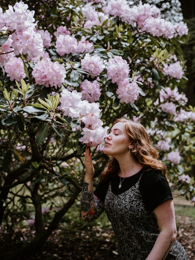 Woman sniffing white and pink blooming flowers
